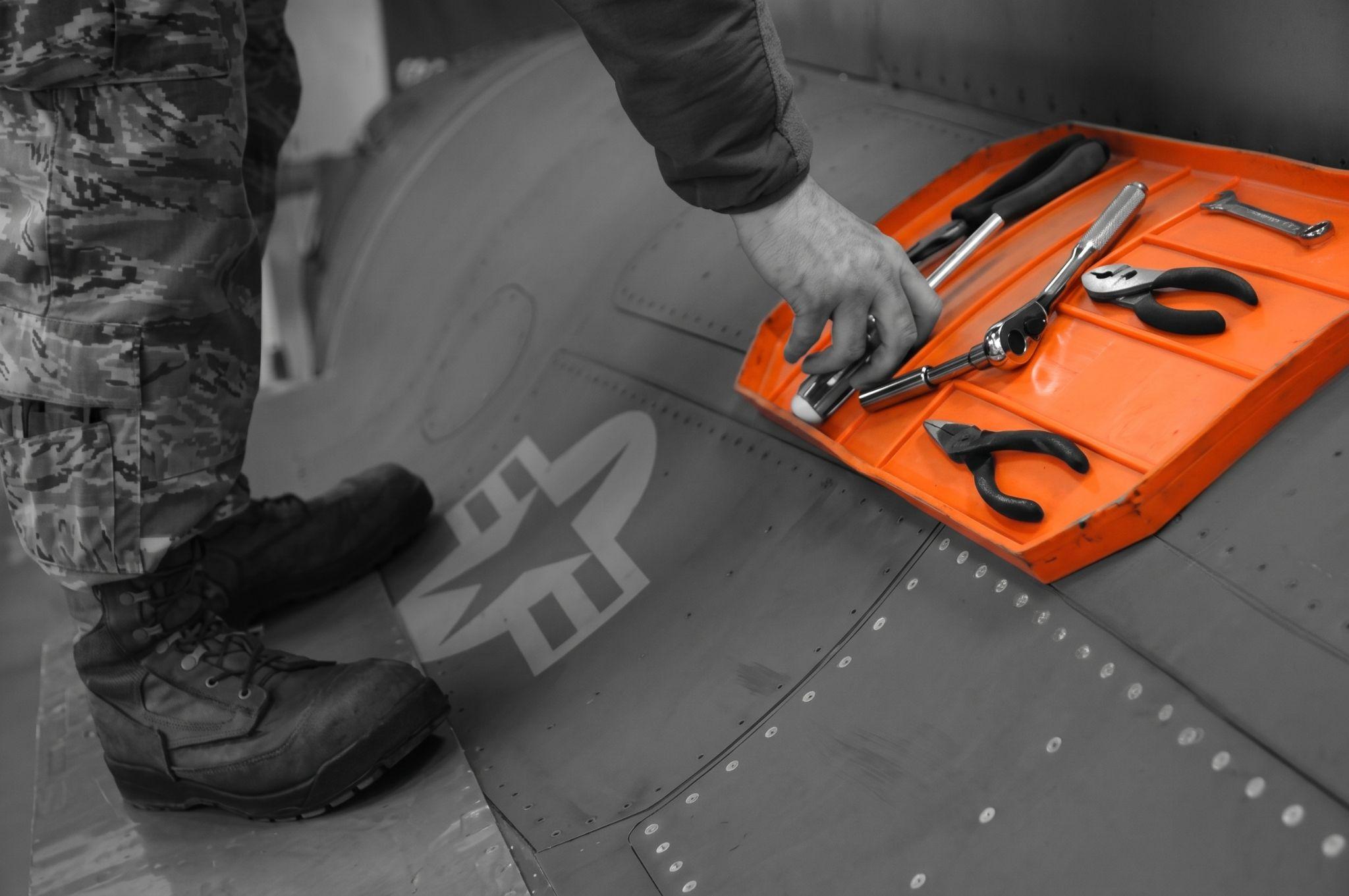 An early Grypmat prototype holding tools on a curved aircraft surface